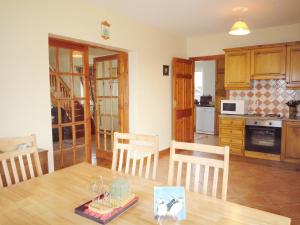 a kitchen and dining room with a table and chairs at Allaghee Mor St Finians Bay in Ballinskelligs