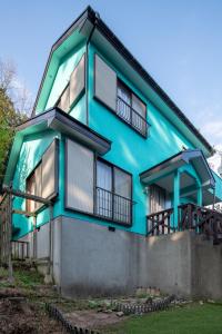 a blue house with windows and balconies at Villent Izukogen in Ito