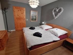 a bedroom with a bed with two bags on it at Komfort Feriendomizil JAKOBI in Dietfurt