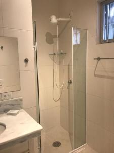 ein Badezimmer mit Dusche mit Glastür in der Unterkunft Beach House in Ubatuba