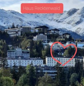 a heart in front of a city in the mountains at Superior Apartment Recktenwald in Bad Gastein