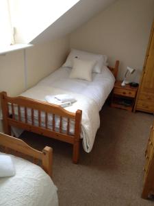 a bedroom with a large bed and a night stand at Arcadia Guest House in Weymouth