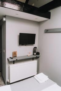 a room with a flat screen tv on a wall at Sgwd Gwladys Lodge in Pont-Nedd-Fechan