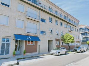 an apartment building with a car parked in front of it at Pensión Boutique ADMERA in Santiago de Compostela