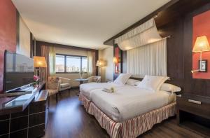 Postel nebo postele na pokoji v ubytování Hotel Cordoba Center
