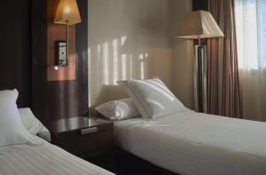Postel nebo postele na pokoji v ubytování Hotel Cordoba Center