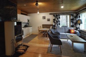 a living room with a couch and a table at RukanEtelärinne H in Ruka