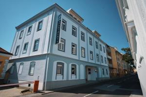 a blue and white building on the side of a street at M-24 Apartments in Mattersburg