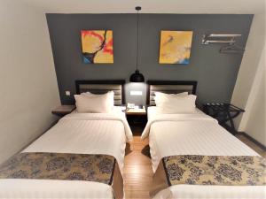 Postel nebo postele na pokoji v ubytování Apple Suites Hotel