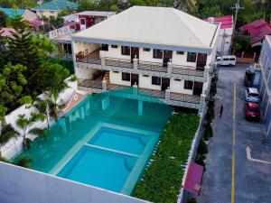 an aerial view of a house with a swimming pool at Hotel Georgina in Maitim