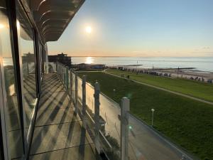 a balcony of a building with a view of the beach at Kaiserblick Norderney in Norderney