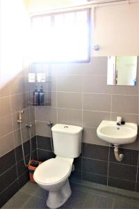 a bathroom with a toilet and a sink at Once In Peninsula Guesthouse by Nestcove in Melaka