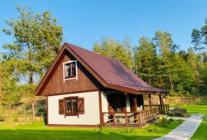 a small house with a brown roof at Domek na Kaszubach nad Jeziorem in Kłodno +5 photos