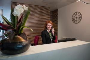 a woman in an office talking on the phone at Hotel at Conference Aston in Birmingham