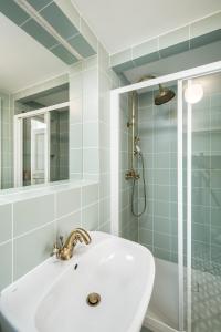 a bathroom with a sink and a shower at Downtown Designer apartment Karlin in Prague