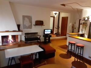 a living room with a fireplace and a table and chairs at Villa con Piscina in Umbria in Foligno