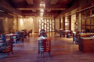 a restaurant with tables and chairs in a room at Bravia Hotel Niamey in Niamey