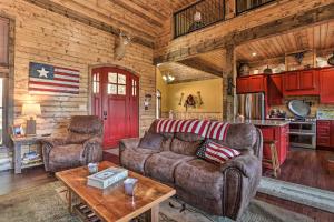 a living room with a couch and a table at Lakefront Norris Lake Cabin with Decks and Dock! in New Tazewell