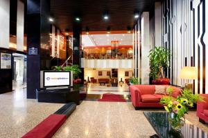 a lobby with a television in a building at Globales Republica in Buenos Aires