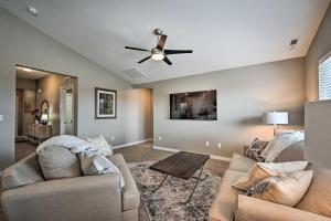 a living room with two couches and a ceiling fan at Modern Caldwell House with Yard and Furnished Patio! in Caldwell