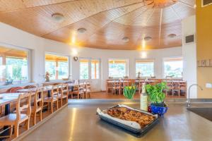 a large dining room with a table with a casserole on it at Farma Slunečný Dvůr in Hermanuv Mestec