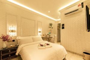 Tempat tidur dalam kamar di AJ Residence - Above Peppermint Asia City