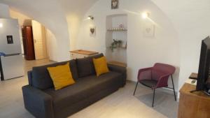 a living room with a couch and a chair at Appartement tout confort 2-4 personnes Joyeuse-ARDECHE in Joyeuse