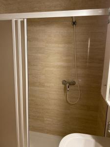 a shower stall with a toilet in a bathroom at Formosa Oporto Apartments Group in Porto