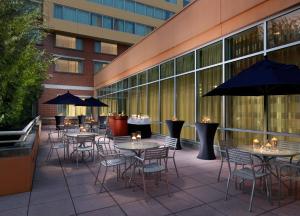 a patio with tables and chairs in front of a building at Georgia Tech Hotel and Conference Center in Atlanta