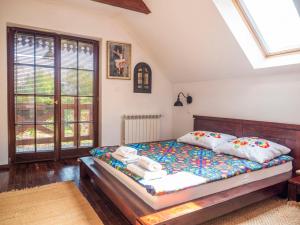 a bedroom with a bed and a skylight at Siedlisko Poleski Zakątek in Lejno
