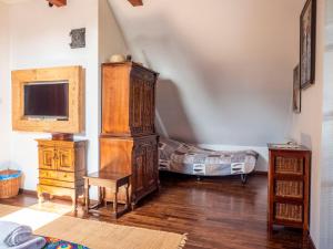 a room with a large wooden cabinet and a bed at Siedlisko Poleski Zakątek in Lejno