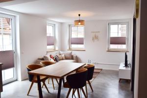 a living room with a table and chairs and a couch at Herberge Bärenschenke in Meßkirch