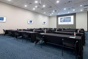 a conference room with tables and chairs and a screen at Holiday Inn Express Hotel & Suites Hermosillo, an IHG Hotel in Hermosillo