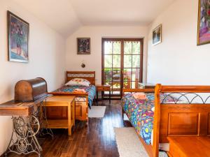 a bedroom with two beds and a desk at Siedlisko Poleski Zakątek in Lejno