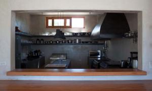 a large kitchen with a counter in the middle at Tribu Todos Santos in Todos Santos