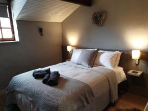 a bedroom with a large bed with two bags on it at Maison Vigneronne in Villeneuve-de-Duras