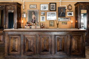 a wooden bar in a room with pictures on the wall at Palihotel Melrose in Los Angeles