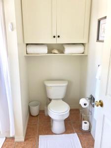 a bathroom with a toilet and some towels at Palm Point Loft in Turtle Cove