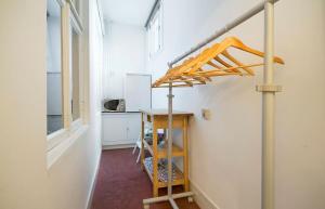 a room with a kitchen with a table and a shelf at Ground floor Jordaan Apartment in Amsterdam