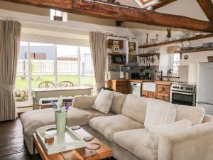 a living room with a couch and a table at The Cowshed in Whitby