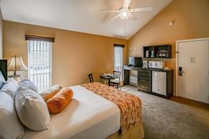 a bedroom with a large bed with a ceiling fan at The Townhouses in Branson