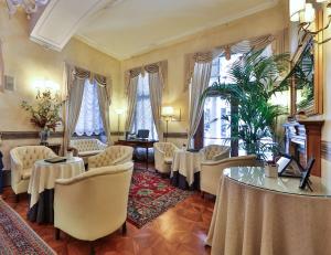 a meeting room with tables and chairs and windows at Best Western Plus Hotel Genova in Turin