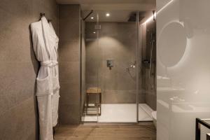a bathroom with a shower with a glass door at Hyatt Regency Malta in St. Julianʼs