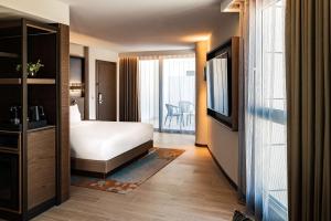 a hotel room with a bed and a television at Hyatt Regency Malta in St. Julianʼs