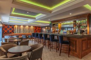 a bar in a restaurant with tables and chairs at Silverbirch Hotel in Omagh