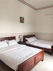 Postel nebo postele na pokoji v ubytování Magnolia Hotel Cam Ranh