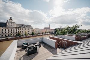 a rooftop deck with a view of a river at EXCLUSIVE Aparthotel MARINA in Wrocław