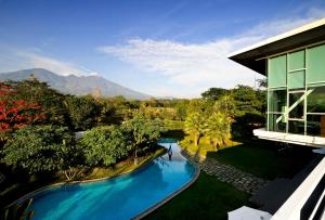 an overhead view of a swimming pool next to a building at K Gallery Hotel in Pasuruan