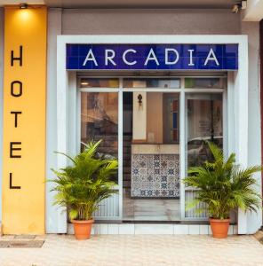 a store front with potted plants in front of it at Hotel Arcadia in Panaji