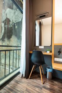 a chair sitting in front of a window in a room at B Street Hotel in George Town